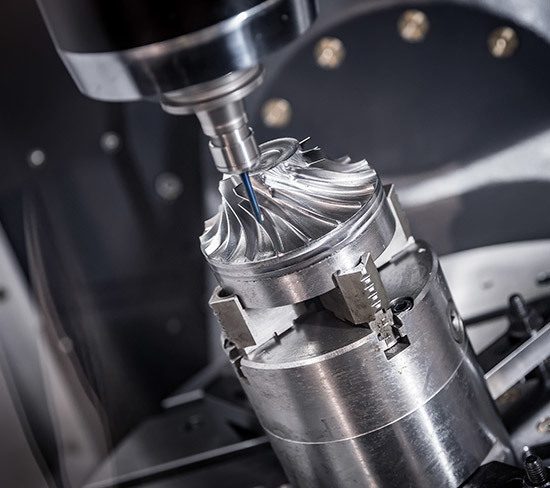 A CNC machine precisely cutting a metal turbine component.