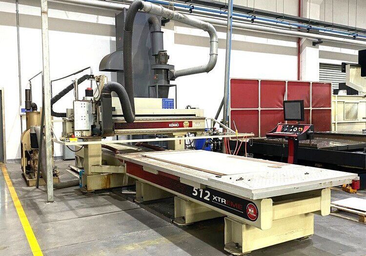CNC router machine in a workshop with a computer control station, metal framework, and exhaust system, labeled "312 Xtreme.